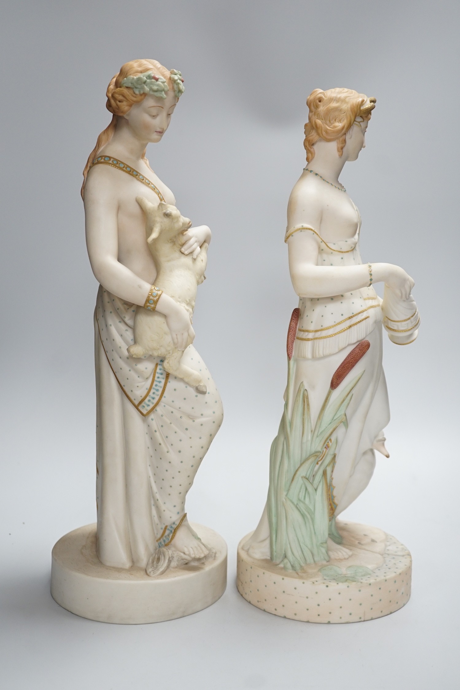 A pair of large W H Goss bisque classical female figures, one with lamb, the other Leda and the Swan, 45cm